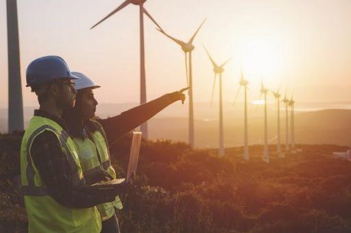 People pointing wind turbines